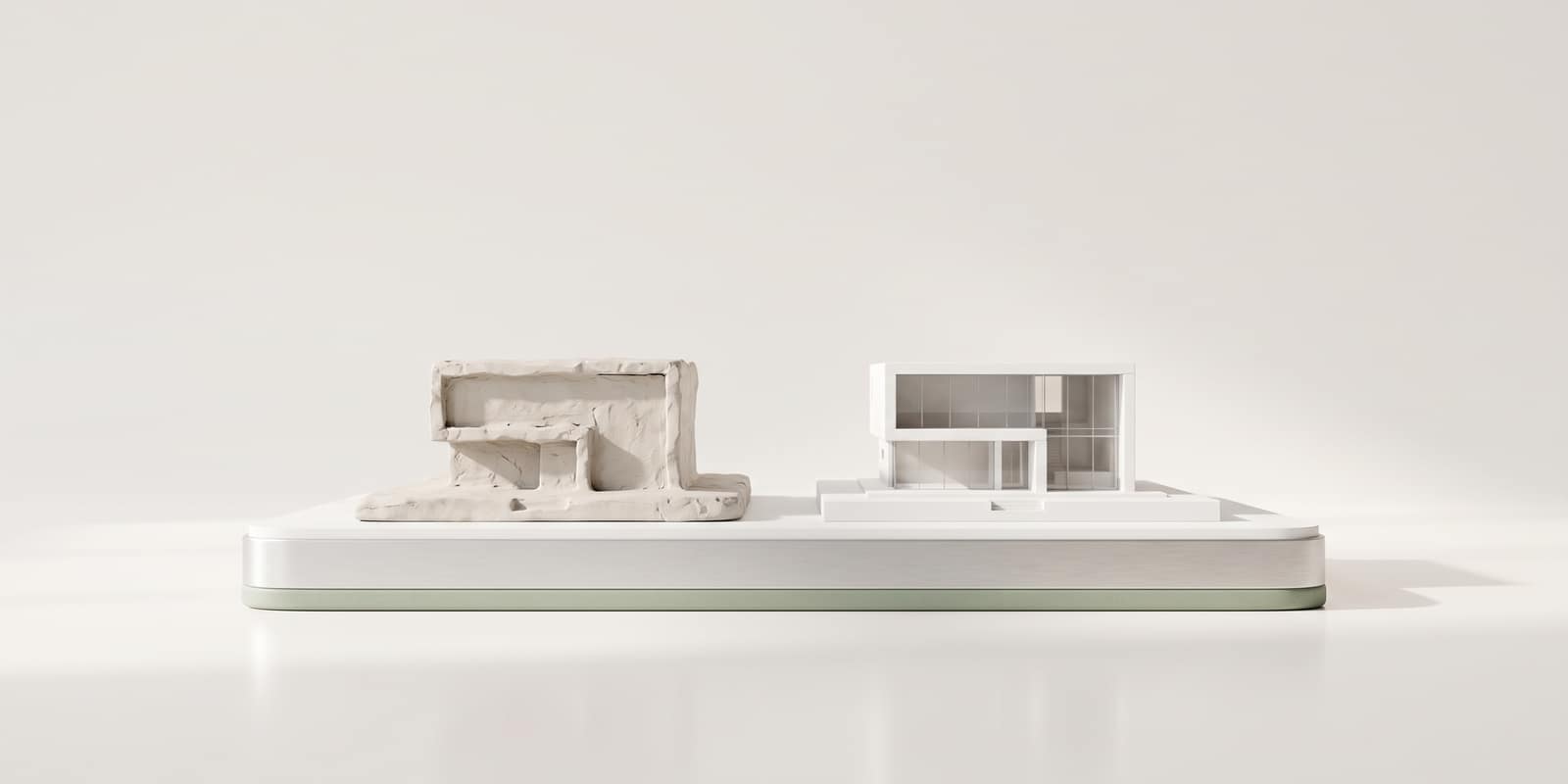 A rough clay sketch model beside the same building finished as a precise white model