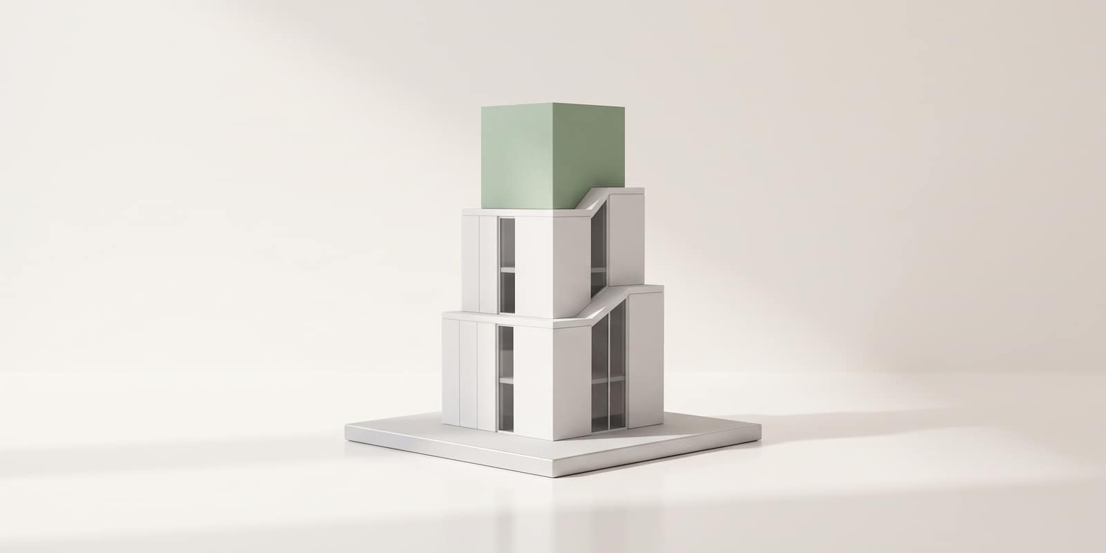 A white model tower rising in stepped tiers, the top tier in sage green